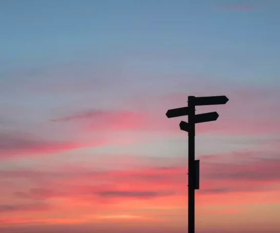 Wegweiserschild vor Sonnenuntergang